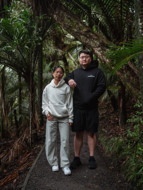 Two people on a bush track wearing Kardiá Hoodies in Snow and Night